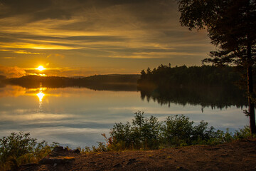 Fototapeta premium Sunset over a magnificent fishing lake in the Canadian forest