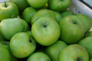 green apples close-up in a basket.