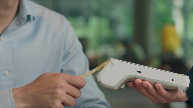 Customer pay food order lunch in cafe unrecognizable man contactless payment technology NFC on phone waiter serving visitor in restaurant male guy paying bank app mobile terminal scan cashless service