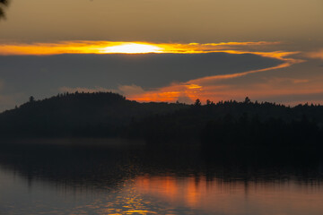 Sunset over a magnificent fishing lake in the Canadian forest