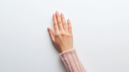 A minimalist photo capturing a delicate hand, elegantly poised, against a pristine white background. Copy space for your custom text. 