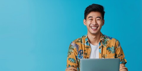 Cheerful young man using laptop. A vibrant image for conveying positivity and engagement in digital activities. Ideal for educational, marketing, and promotional content