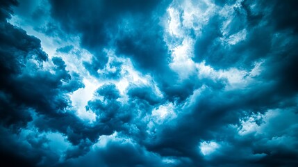 A dark blue sky with some clouds in it