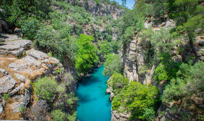 In this breathtaking aerial stock video, the mesmerizing ruins of an aqueduct stand gracefully near the ancient city of Aspendos in the captivating region of Antalya, Turkey. The camera sweeps above