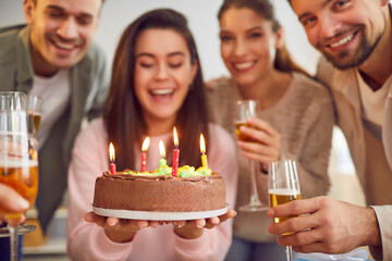 Candles blowing cake, happy birthday celebration, friendly group family portrait, young friends party together for special event. Smiling people gathering making fun, wishing great happiness, drinking