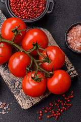 Juicy ripe red cherry tomatoes on a branch