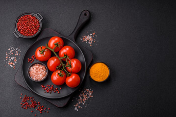Juicy ripe red cherry tomatoes on a branch