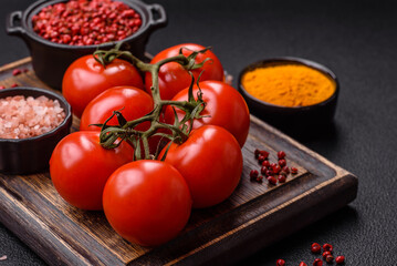 Juicy ripe red cherry tomatoes on a branch