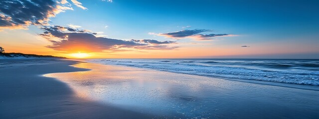 Fototapeta premium Beautiful beach sunset with a blue sky and ocean wave