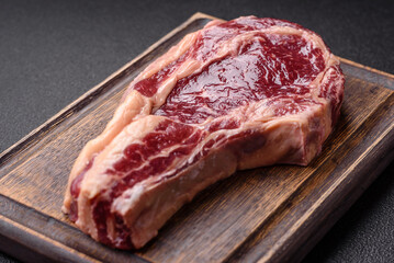 Fresh, raw beef steak with salt, spices and herbs