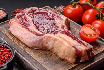 Fresh, raw beef steak with salt, spices and herbs