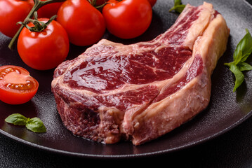 Fresh, raw beef steak with salt, spices and herbs