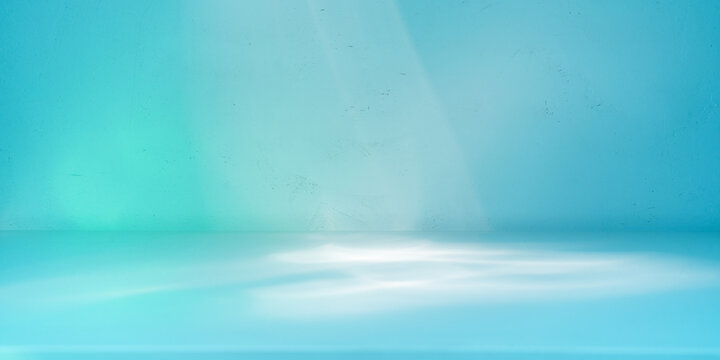 Light background with distracted light on the wall and table. Cold blue colors. Panoramic background for product presentation.