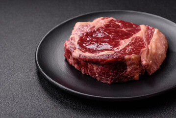 Fresh, raw beef steak with salt, spices and herbs