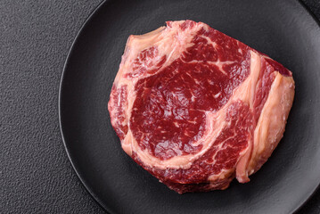 Fresh, raw beef steak with salt, spices and herbs