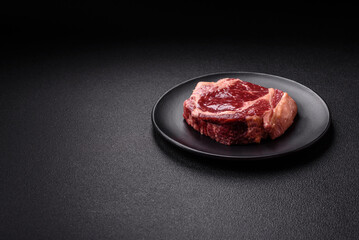 Fresh, raw beef steak with salt, spices and herbs