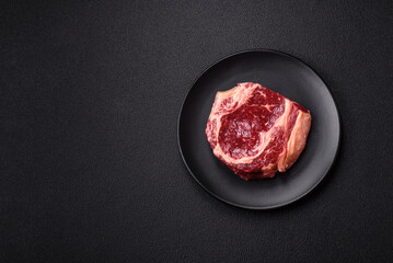 Fresh, raw beef steak with salt, spices and herbs