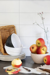 Peeled apple and utensils on kitchen table