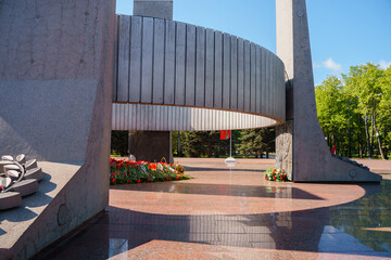 Eternal flame in the middle of red carnations and different colors, Victory Day holiday on May 9th...