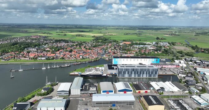 Makkum, village in Friesland, along the Ijsselmeer, industrial port with lagre ship builder. Aerial drone view.