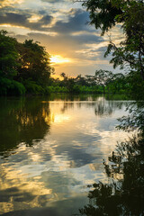 landscape lake views and the reservoir the forest summer water reflection with Twilight blue bright and orange yellow dramatic sunset sky in beach colorful nature background.