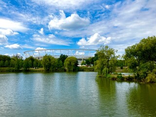 Obraz premium A beautiful view of the landscape over a lake on the Silesian Stadium in Chorzów, Poland