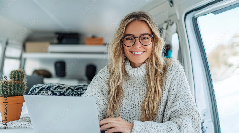 Wall mural young woman working remotely on laptop in camper van