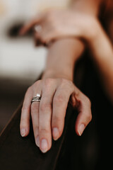 Elegant female hand with diamond ring on finger, white gold jewelry details