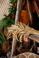decorations with wheat and other plants in a vase and an embroidered ornament