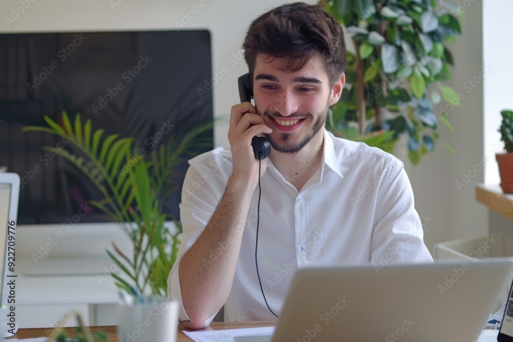 Poster man using cell phone at his desk