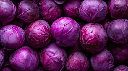 Obraz premium Vibrant and beautifully rich purple cabbage heads intricately piled together, perfect for various foodrelated designs