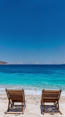 Fototapeta premium white sand beach chairs