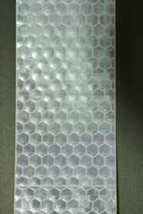 Hexagonal reflective material texture close-up
Close-up of a hexagonal pattern on a reflective...