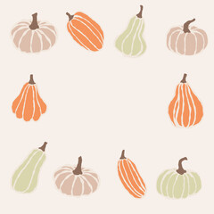 A diverse collection of pumpkins and gourds arranged in a decorative frame for autumn festivities