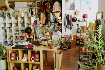 Chic boutique showcasing an assortment of fashion accessories, clothing, and numerous house plants...