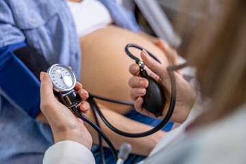 Doctor measuring blood pressure of a pregnant woman on third trimester