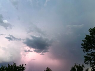 stormy sky, heavy lead clouds in the sun's rays, bad weather, lightning