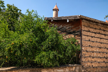 The "buttoned houses" found in the highest districts of Antalya above sea level represent the traditional residential architecture of a rural environment.