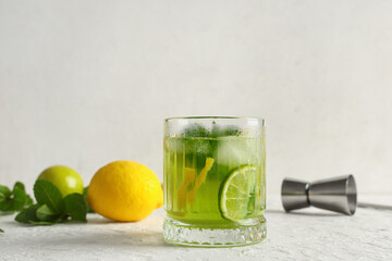 Glass of tasty lemonade with mint, lime and lemon on white background