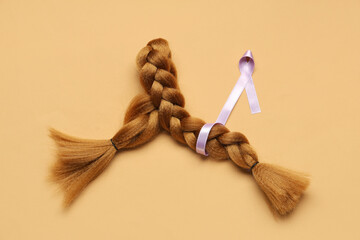 Braided red hair for donation with purple awareness ribbon on orange background