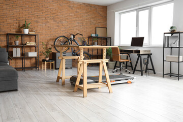 Interior of modern office with desks, treadmill and bicycle