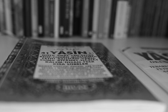 Quran book part in front of the books