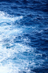 View from above of blue sea waves and sea foam of Mediterranean Sea surface