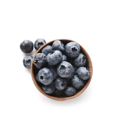 Wooden bowl of ripe blueberry on white background, closeup