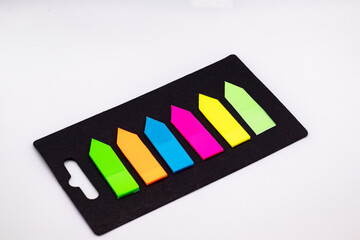 Set of multi-colored self-adhesive markers on white background