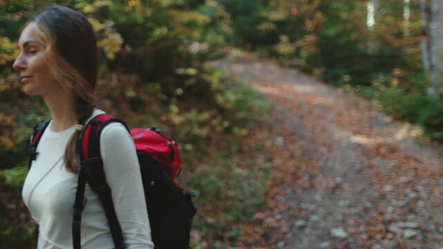 Hiker is enjoying the peacefulness of nature while walking on a path in a mountain forest in the carpathian mountains, ukraine