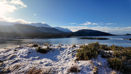 Lapataia Bay At Ushuaia In Tierra Del Fuego Argentina. Snowy Mountains. Bay Water Landscape. Tierra Del Fuego Argentina. Lake Background. Lapataia Bay At Ushuaia In Tierra Del Fuego Argentina.