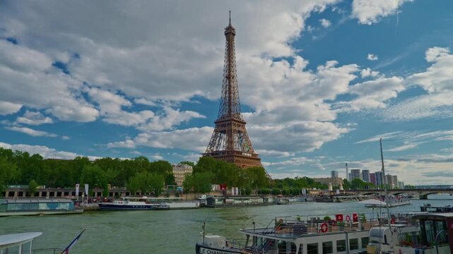 Timelapse of the Eiffel Tower along the river Seine with flyboats passing by with motion blur. Sunny but cloudy spring summer day paris city famous riverside bay tower view bridge time lapse panorama