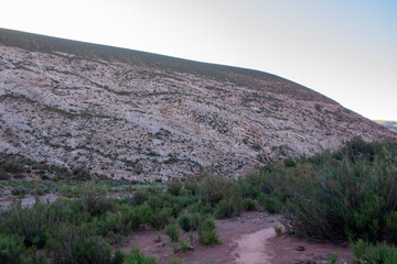 Path to advance on foot in a natural desert mountain of an open-air cave