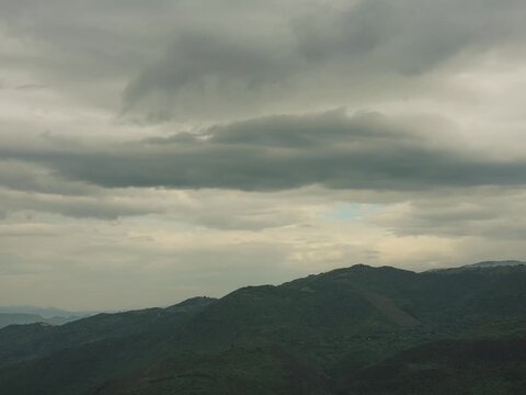 Time-lapse of a valley with clouds and an approaching storm